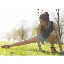 Woman stretching her legs - joint mobility and flexibility with curcumin supplements